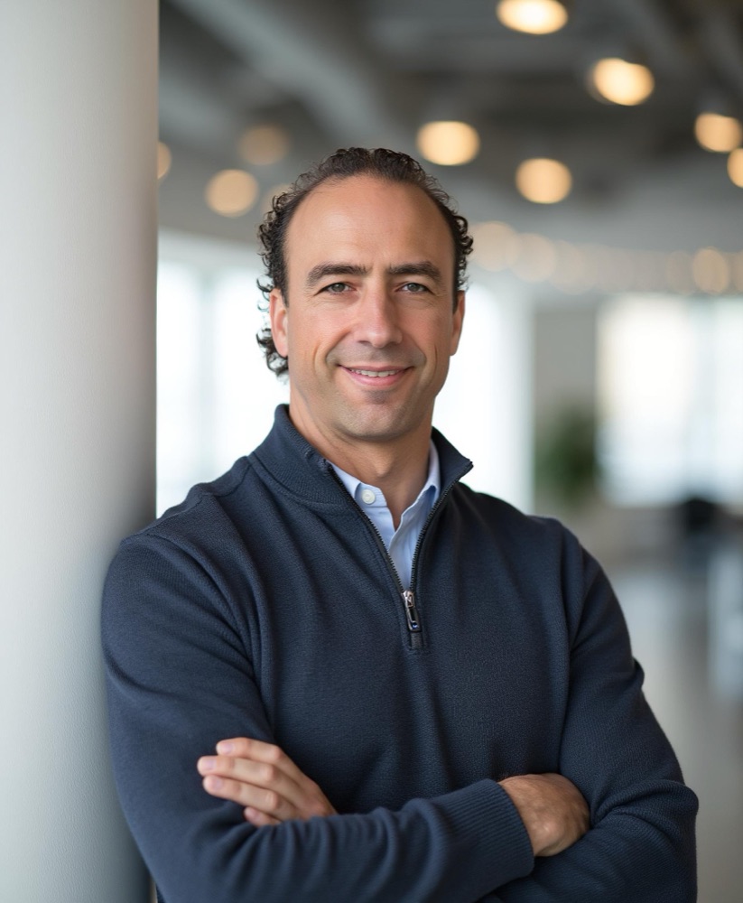 Dr. Mike Hauman, founder of Aslan Health, smiling in a modern office